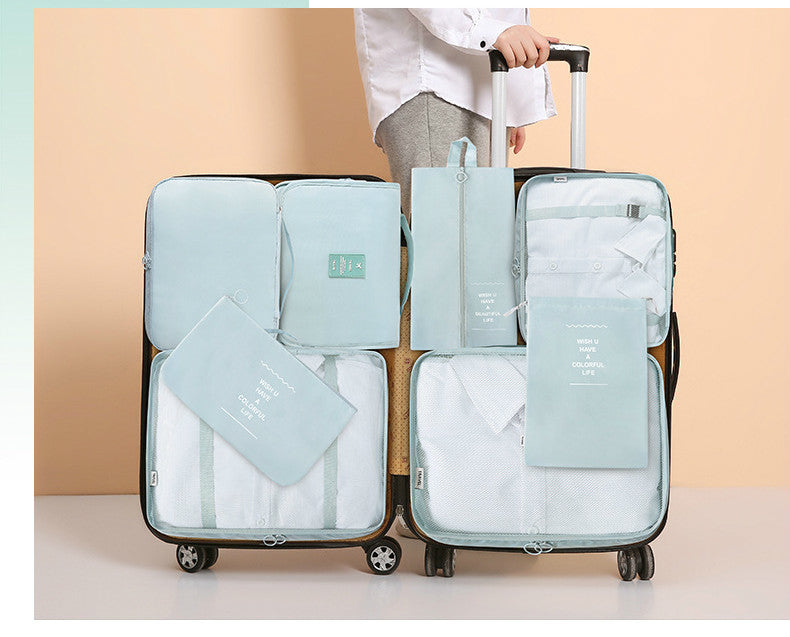 Travel packing cube set arranged inside a suitcase